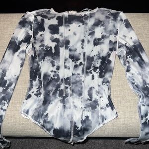 Fashionova Women’s distressed bodysuit with bottom snap closure and back zip.